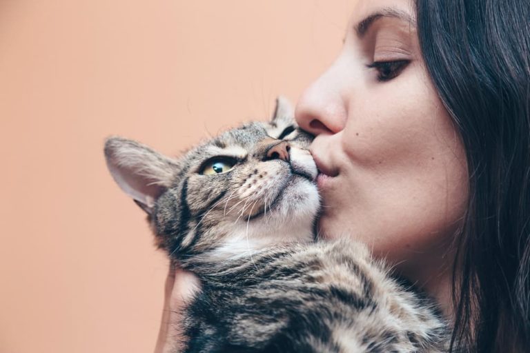 Woman kissing her cat
